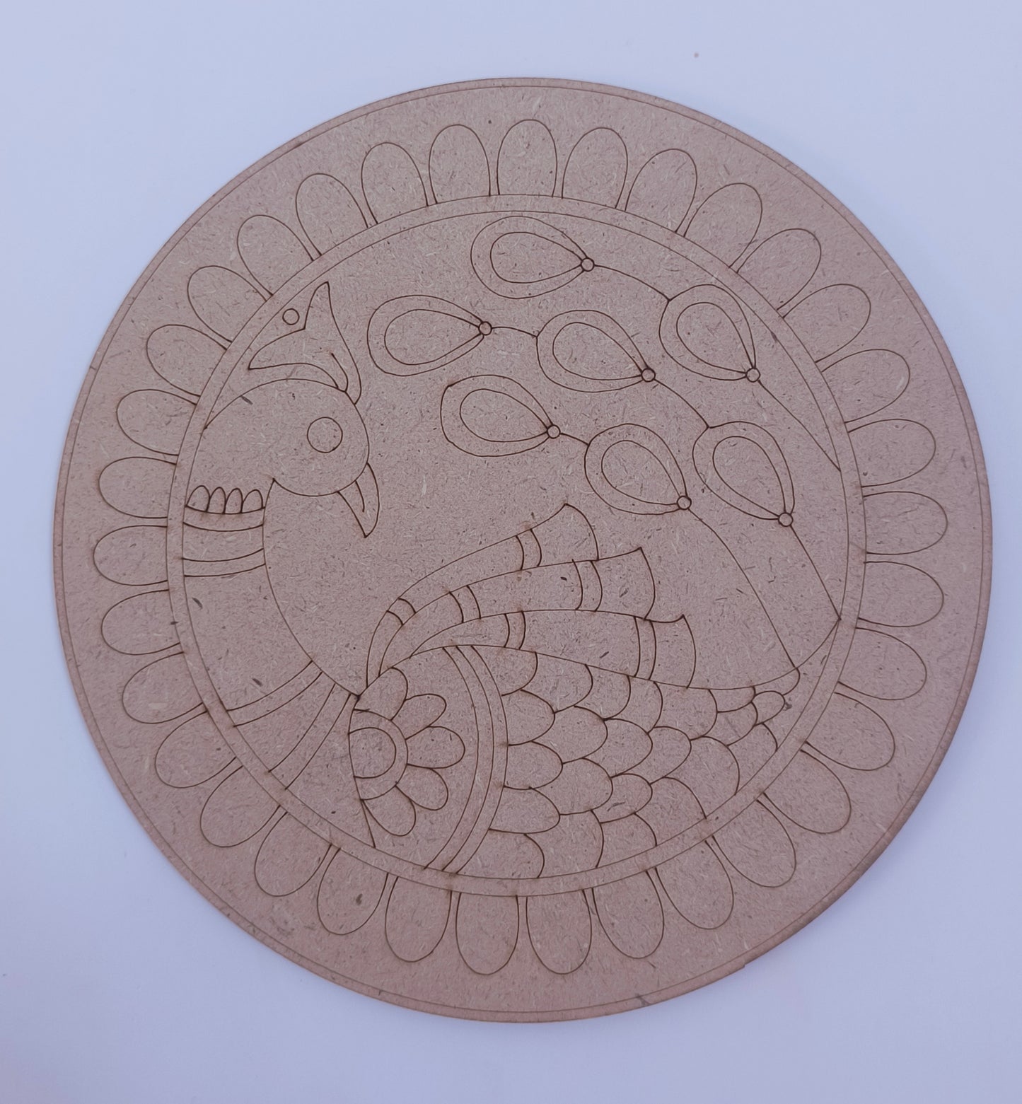 A round MDF board with peacock design placed on a white background.